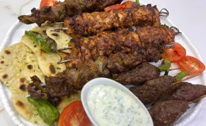 Image of a sizzling kofta kebab on the grill: "Perfectly grilled kofta kebab