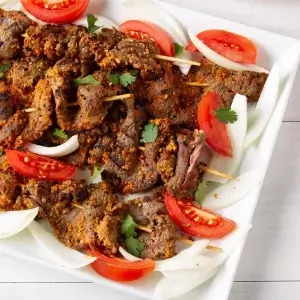 Beef Suya with onions and tomatoes